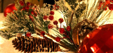 An arrangement of flowers and pine cones.